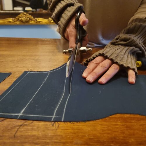 hands cutting fabric during tailoring class