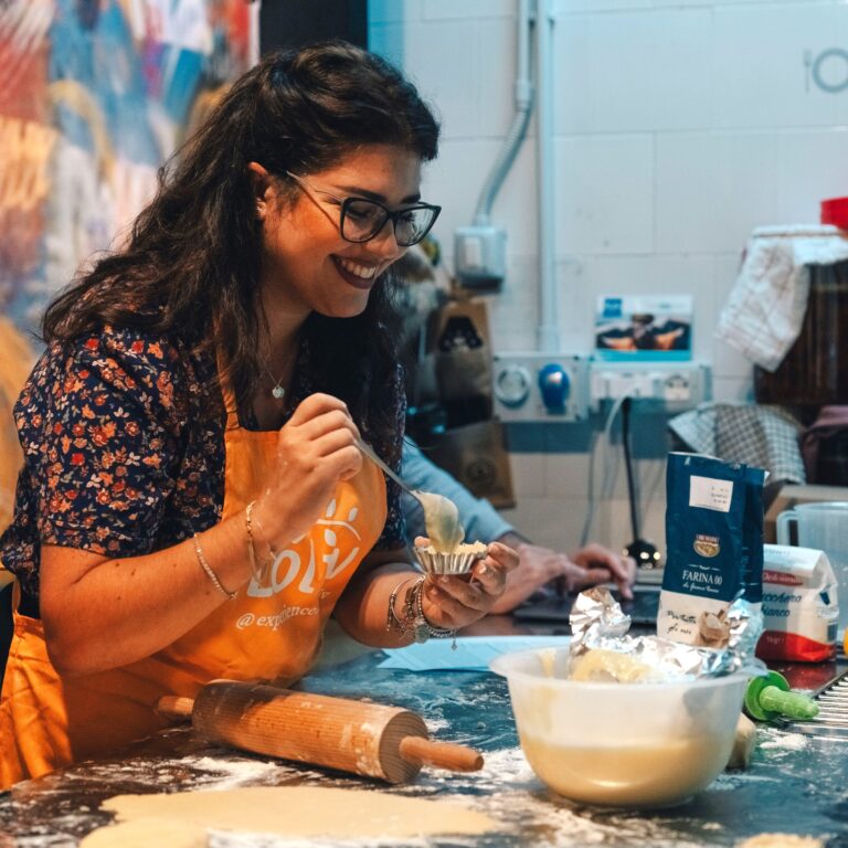 Girl filling a Lecce pasticciotto during a pastry cooking class