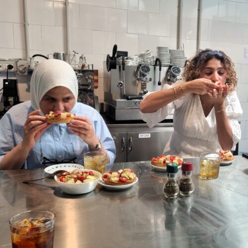 two ladies enjoy frisella with cialedda during the tasting of the Apulian cooking class
