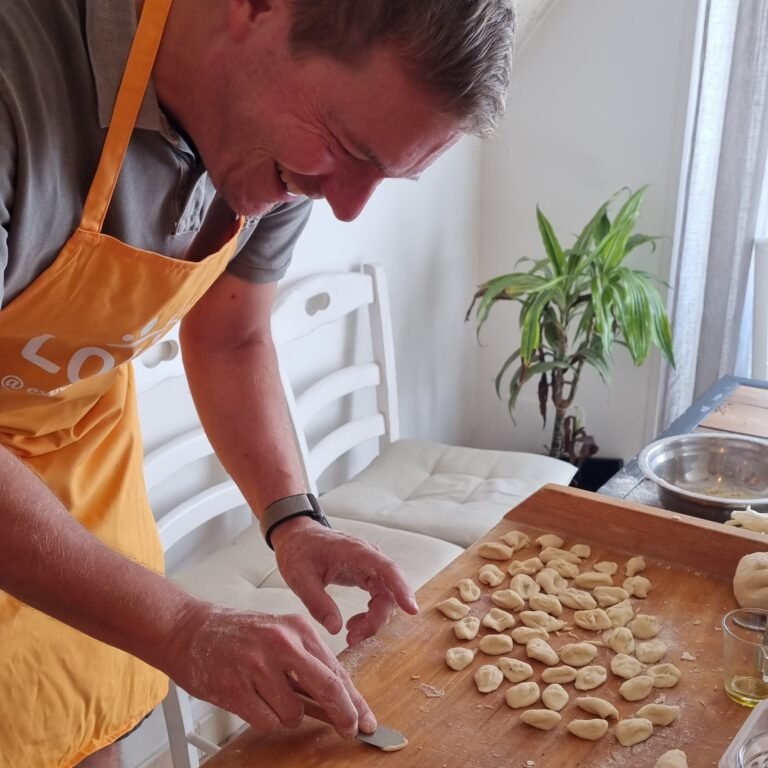 Making orecchiette, a traditional Apulian pasta, during the cooking experience