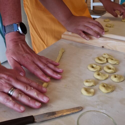 Preparing taralli during the cooking class in Puglia