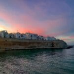 Monopoli at sunset, with vibrant sky and clear sea