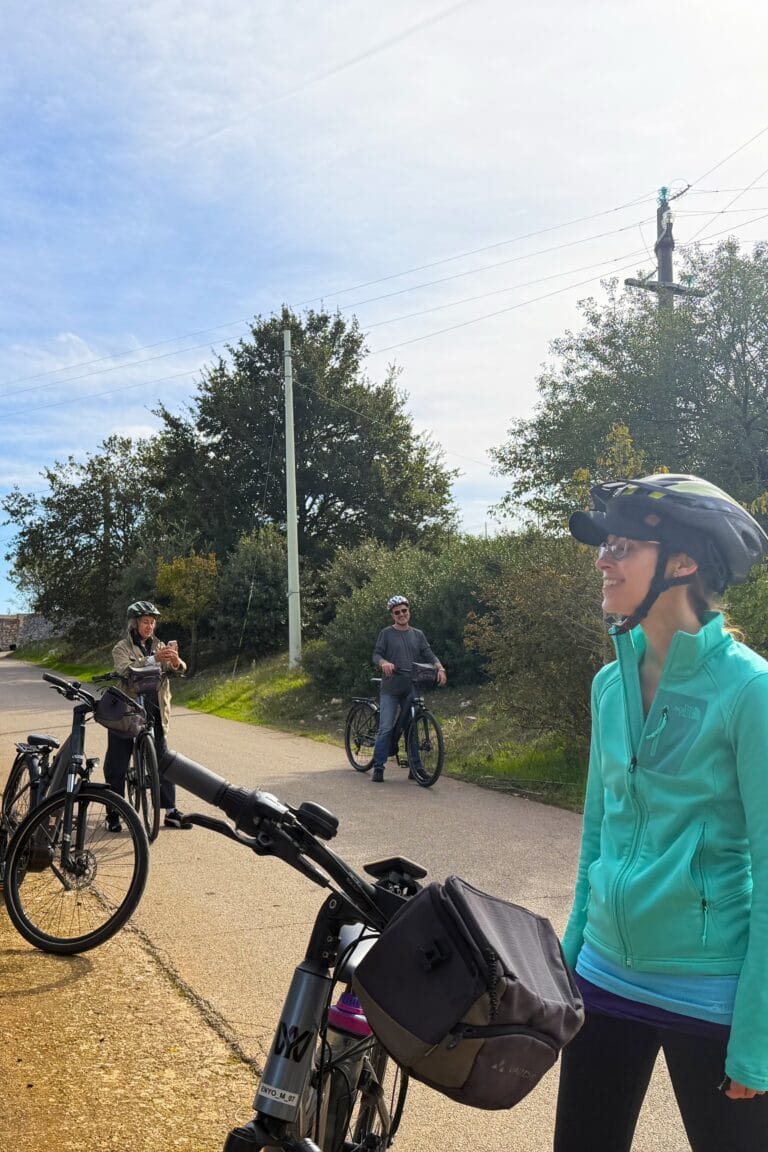 Travellers cycling along quiet country roads in the Apulian countryside, enjoying the scenery and the mild climate