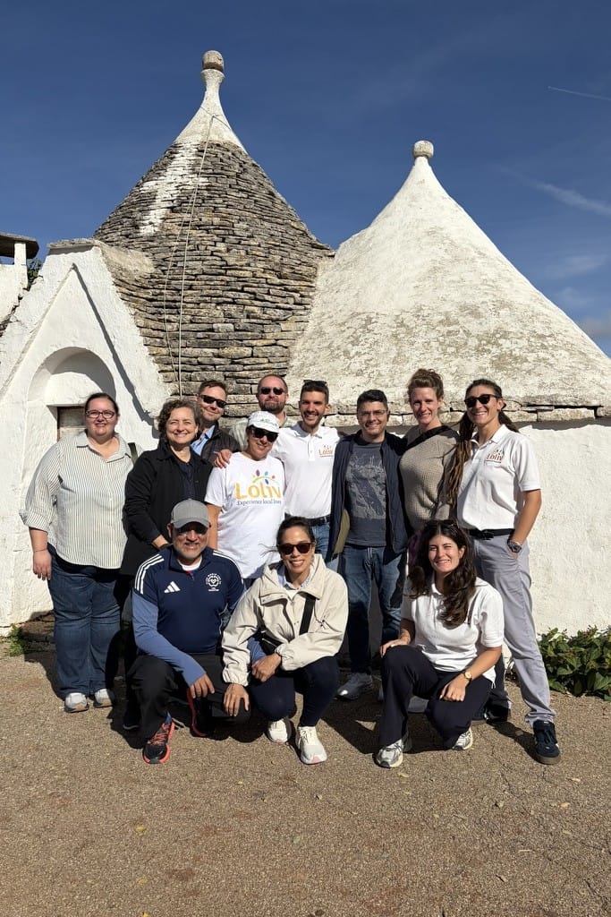Group photo in front of the UNESCO trulli of Alberobello, taken while exploring one of Puglia’s most characteristic historic sites
