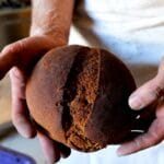Local producer holding a traditional loaf of Marocca bread
