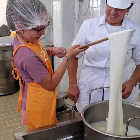 Little girl works the "pasta filata" during the mozzarella tour