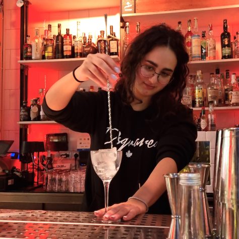 A girl learns to mix ingredients at cocktail making experience