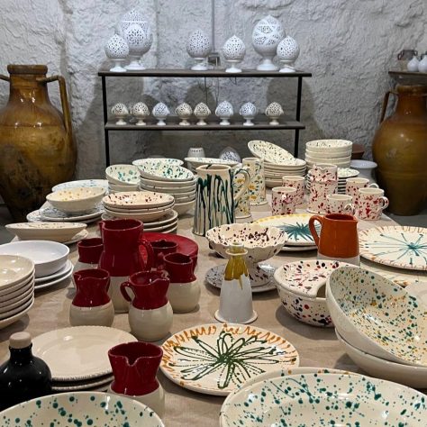 ceramic plates, cups and glasses on display at the pottery workshop in Grottaglie